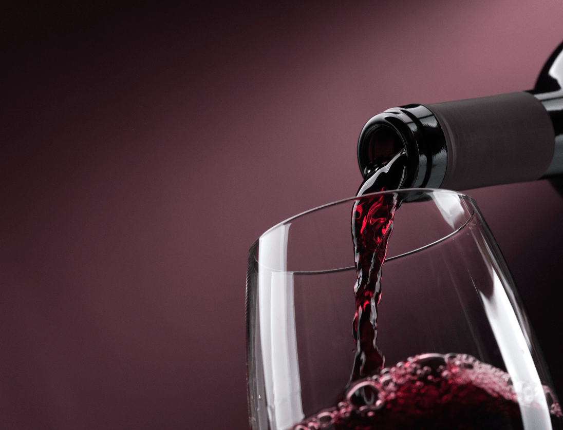 Pouring red wine into a wineglass@2x min 1